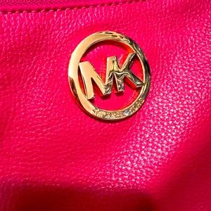 Michael Kors wristlet in pink.